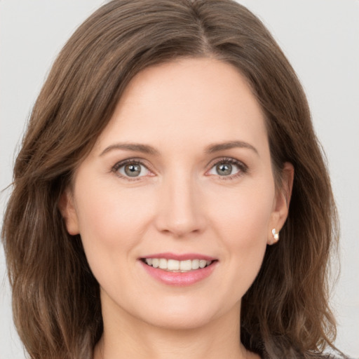 Joyful white young-adult female with long  brown hair and grey eyes