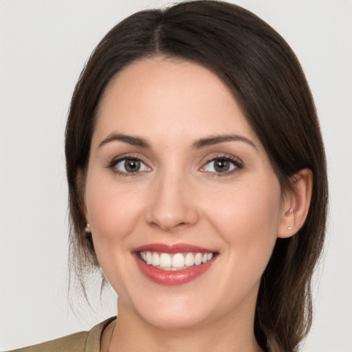 Joyful white young-adult female with medium  brown hair and brown eyes