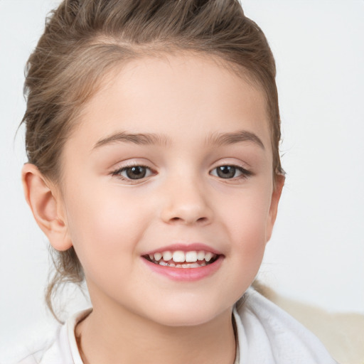 Joyful white child female with medium  brown hair and brown eyes