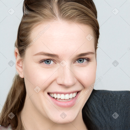 Joyful white young-adult female with long  brown hair and blue eyes