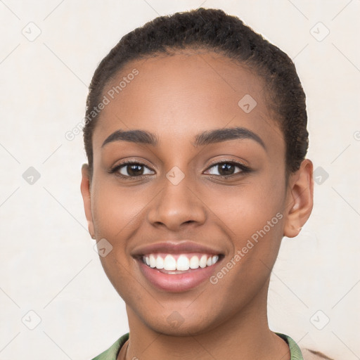 Joyful latino young-adult female with short  brown hair and brown eyes