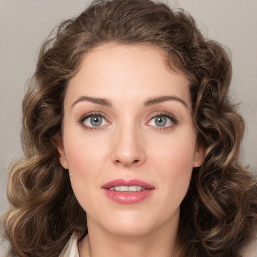 Joyful white young-adult female with long  brown hair and green eyes