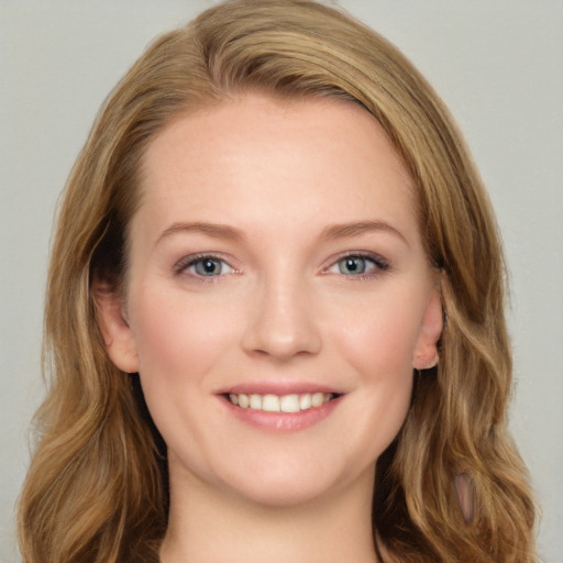 Joyful white young-adult female with long  brown hair and blue eyes