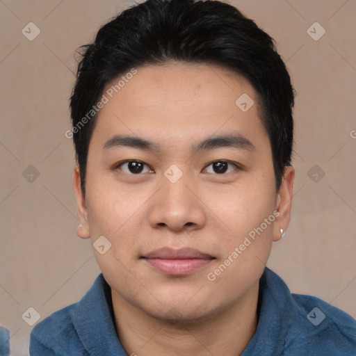 Joyful asian young-adult male with short  black hair and brown eyes