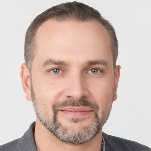 Joyful white adult male with short  brown hair and grey eyes