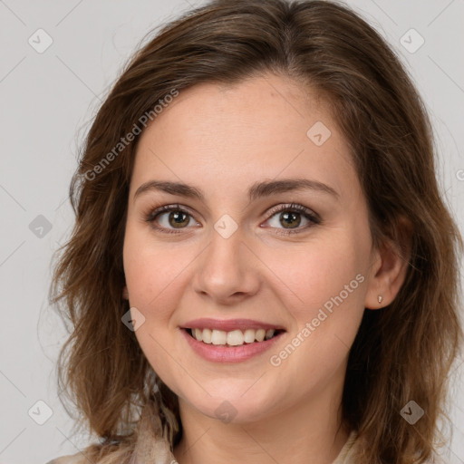 Joyful white young-adult female with long  brown hair and green eyes