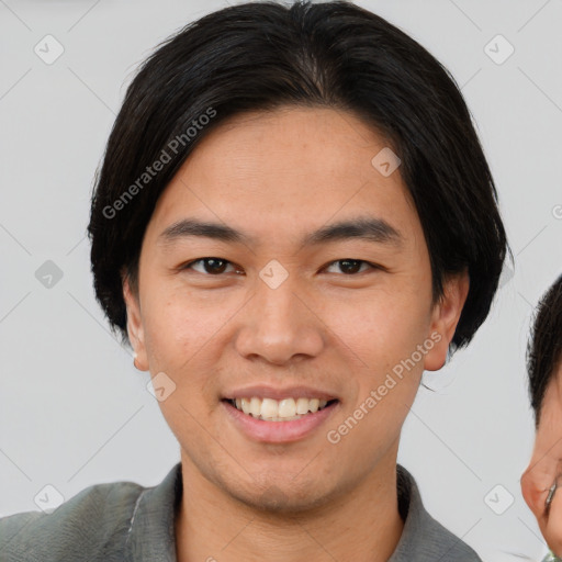 Joyful asian young-adult male with short  brown hair and brown eyes