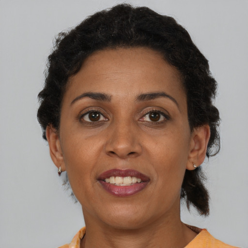 Joyful black adult female with short  brown hair and brown eyes