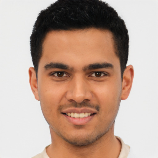 Joyful latino young-adult male with short  brown hair and brown eyes