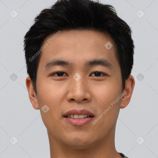 Joyful asian young-adult male with short  black hair and brown eyes