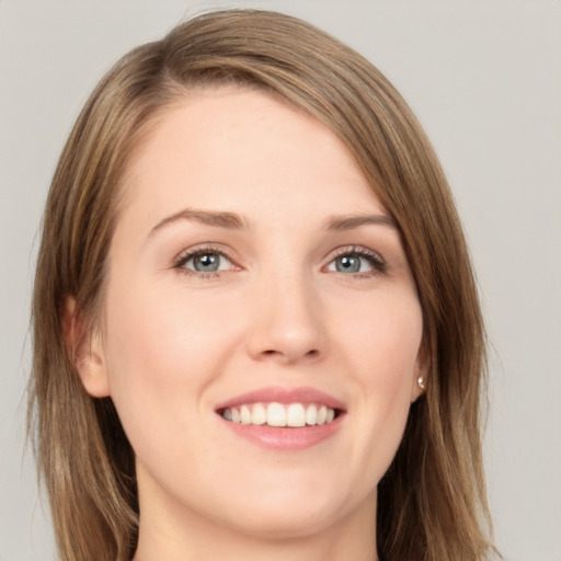 Joyful white young-adult female with medium  brown hair and green eyes