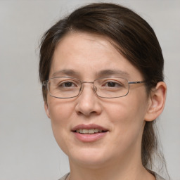 Joyful white adult female with medium  brown hair and grey eyes