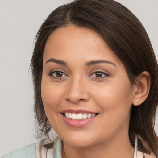 Joyful white young-adult female with long  brown hair and brown eyes