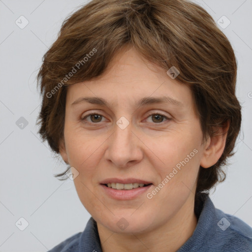 Joyful white adult female with medium  brown hair and grey eyes