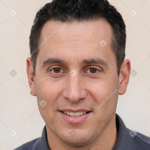 Joyful white adult male with short  brown hair and brown eyes