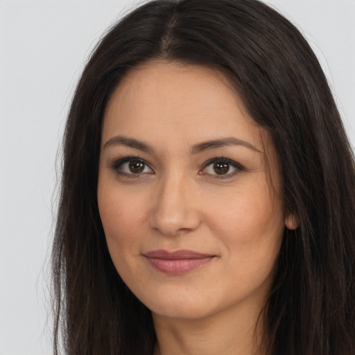 Joyful latino young-adult female with long  brown hair and brown eyes