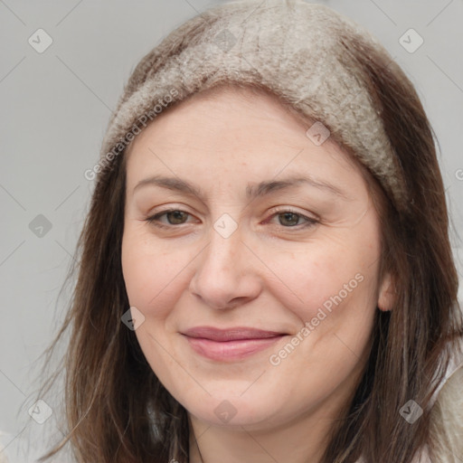 Joyful white adult female with medium  brown hair and brown eyes