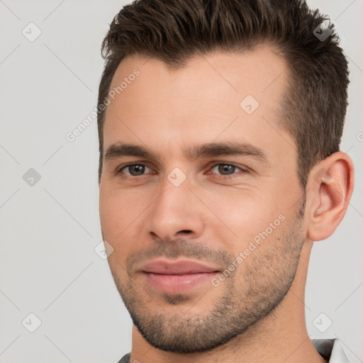 Joyful white young-adult male with short  brown hair and brown eyes