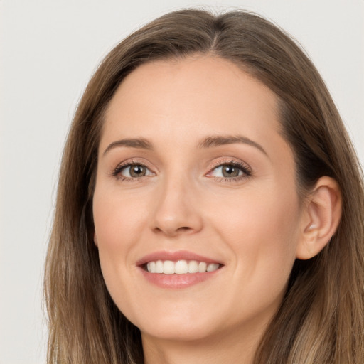 Joyful white young-adult female with long  brown hair and grey eyes