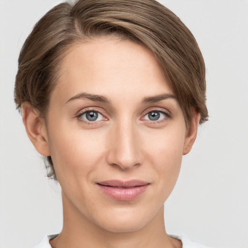 Joyful white young-adult female with medium  brown hair and grey eyes