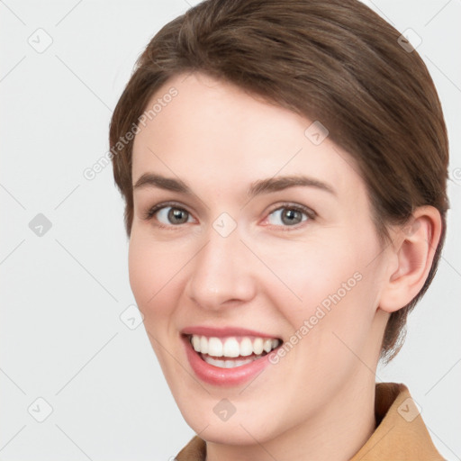 Joyful white young-adult female with short  brown hair and grey eyes