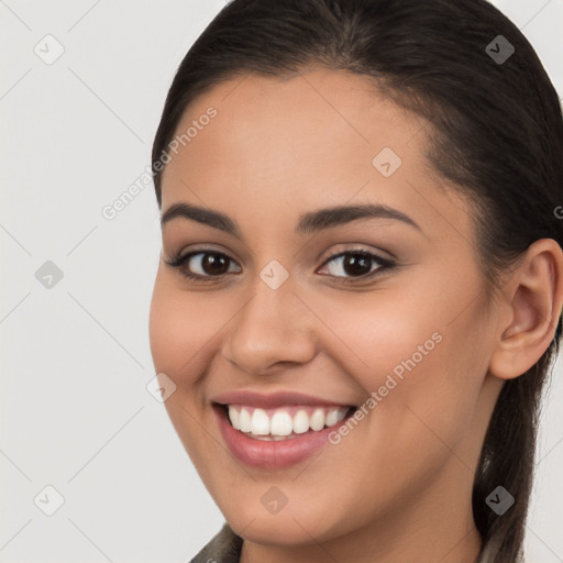 Joyful white young-adult female with long  brown hair and brown eyes