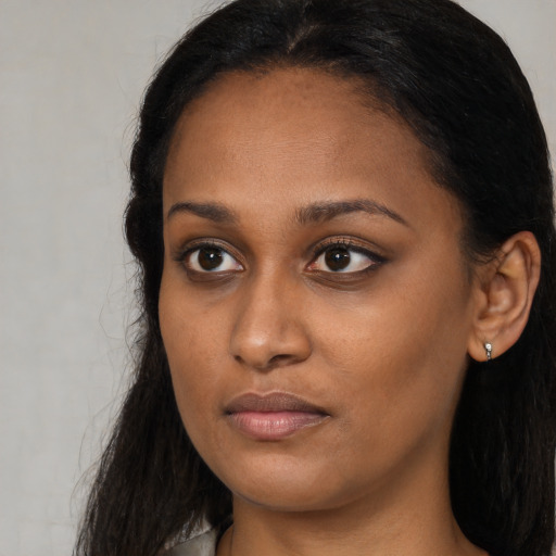 Neutral black young-adult female with long  brown hair and brown eyes