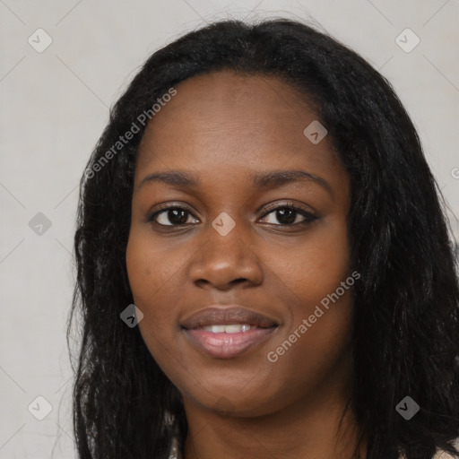 Joyful black young-adult female with long  black hair and brown eyes