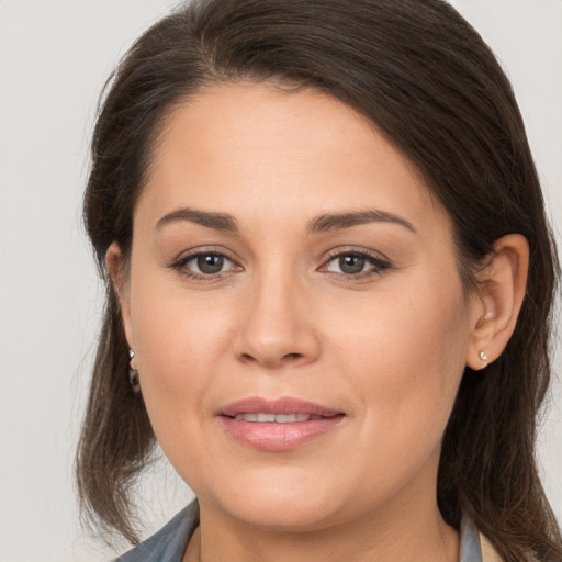 Joyful white young-adult female with medium  brown hair and brown eyes