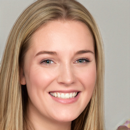 Joyful white young-adult female with long  brown hair and blue eyes