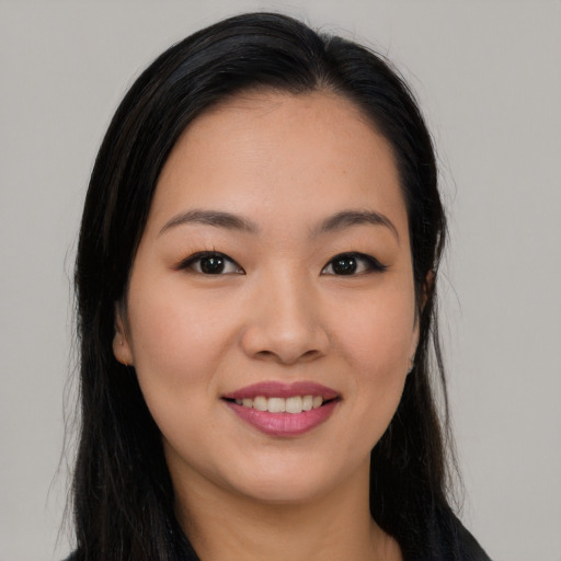 Joyful asian young-adult female with long  black hair and brown eyes