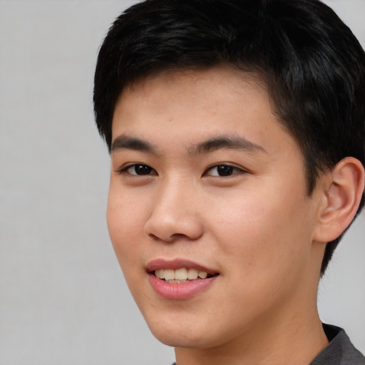 Joyful asian young-adult male with short  black hair and brown eyes
