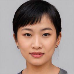 Joyful asian young-adult female with short  black hair and brown eyes