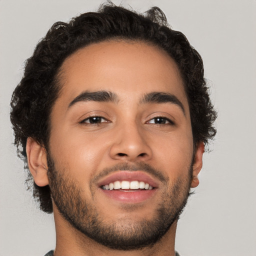 Joyful latino young-adult male with short  brown hair and brown eyes