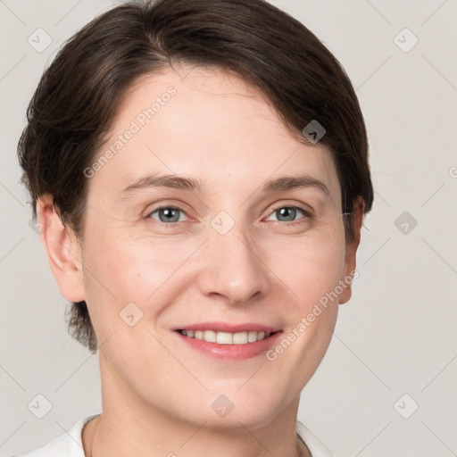 Joyful white young-adult female with short  brown hair and grey eyes