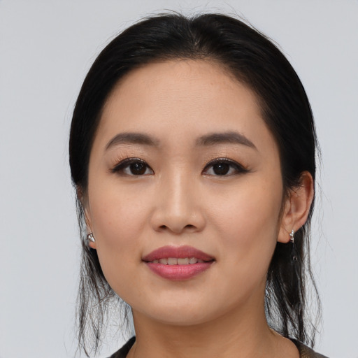 Joyful asian young-adult female with medium  black hair and brown eyes