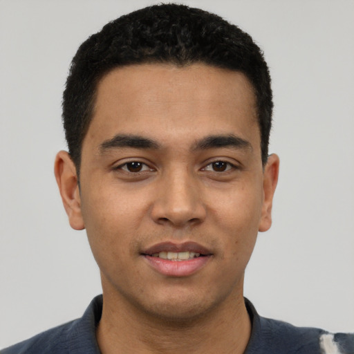 Joyful latino young-adult male with short  black hair and brown eyes