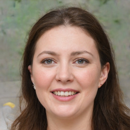 Joyful white young-adult female with medium  brown hair and grey eyes