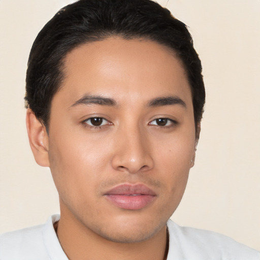 Joyful latino young-adult male with short  brown hair and brown eyes