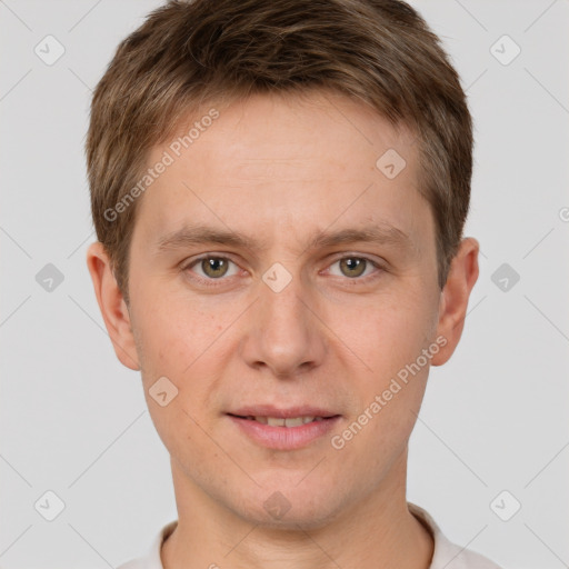 Joyful white young-adult male with short  brown hair and grey eyes