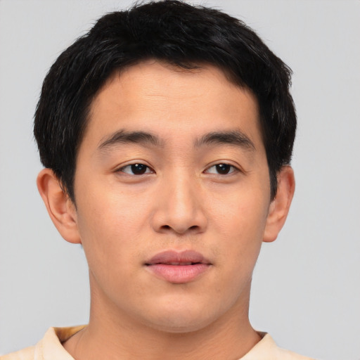Joyful asian young-adult male with short  brown hair and brown eyes