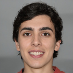 Joyful white young-adult male with medium  brown hair and brown eyes