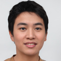 Joyful asian young-adult male with short  brown hair and brown eyes