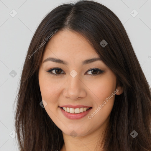 Joyful asian young-adult female with long  brown hair and brown eyes