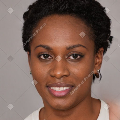 Joyful black young-adult female with short  brown hair and brown eyes