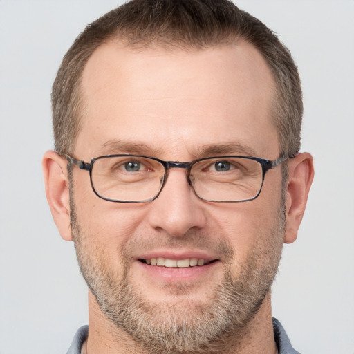 Joyful white adult male with short  brown hair and grey eyes