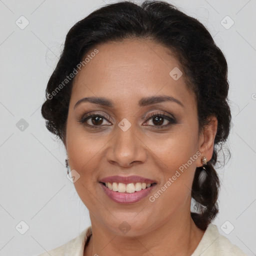 Joyful latino adult female with medium  brown hair and brown eyes