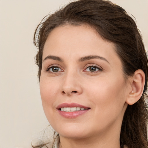 Joyful white young-adult female with long  brown hair and grey eyes