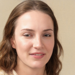 Joyful white young-adult female with long  brown hair and blue eyes