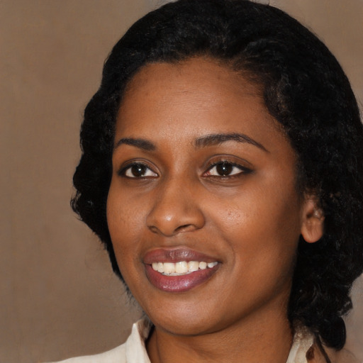 Joyful black young-adult female with medium  black hair and brown eyes